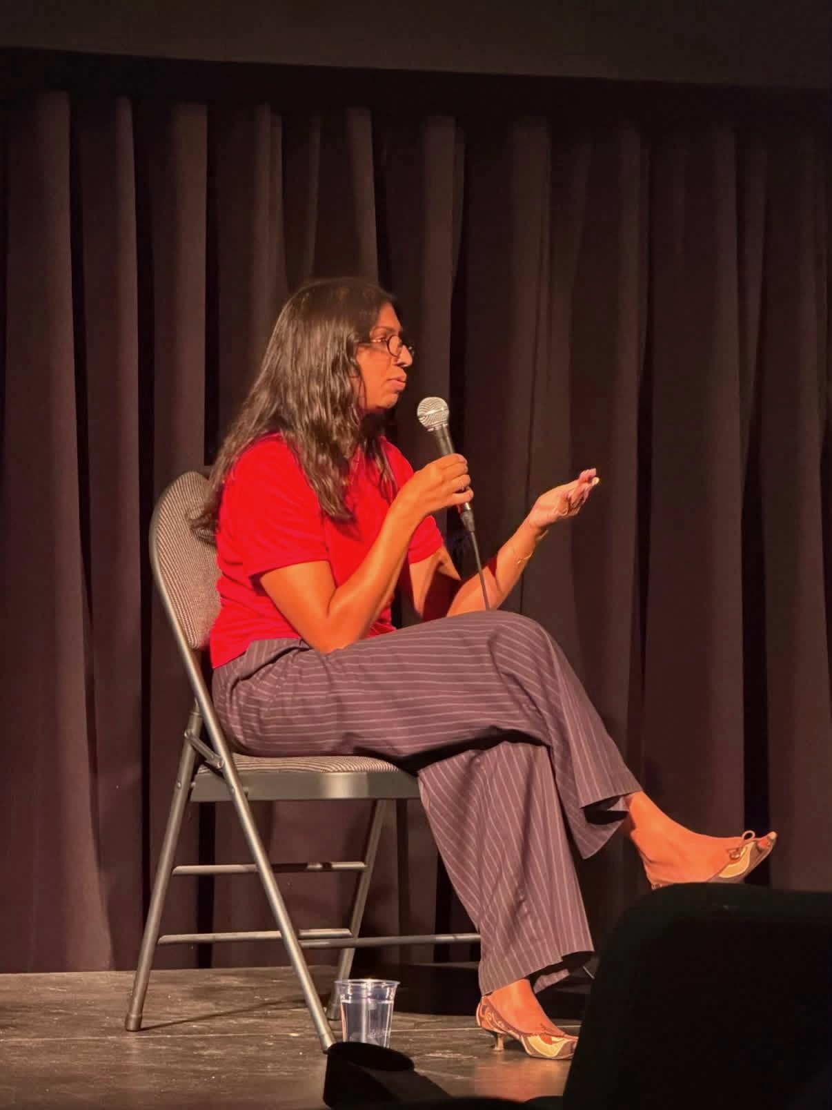 Natasha Goel speaking on stage